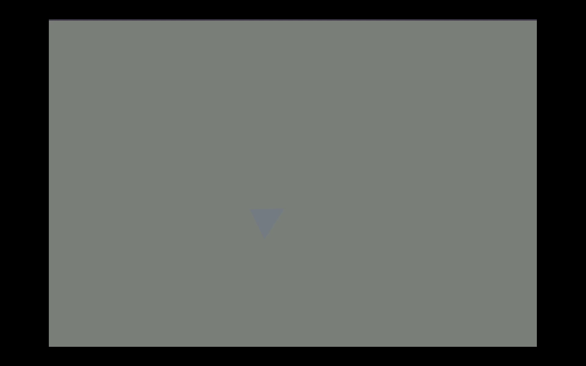 A tilted green triangle rotates slowly on a muted tan background, shifting color and suggesting direction and motion.